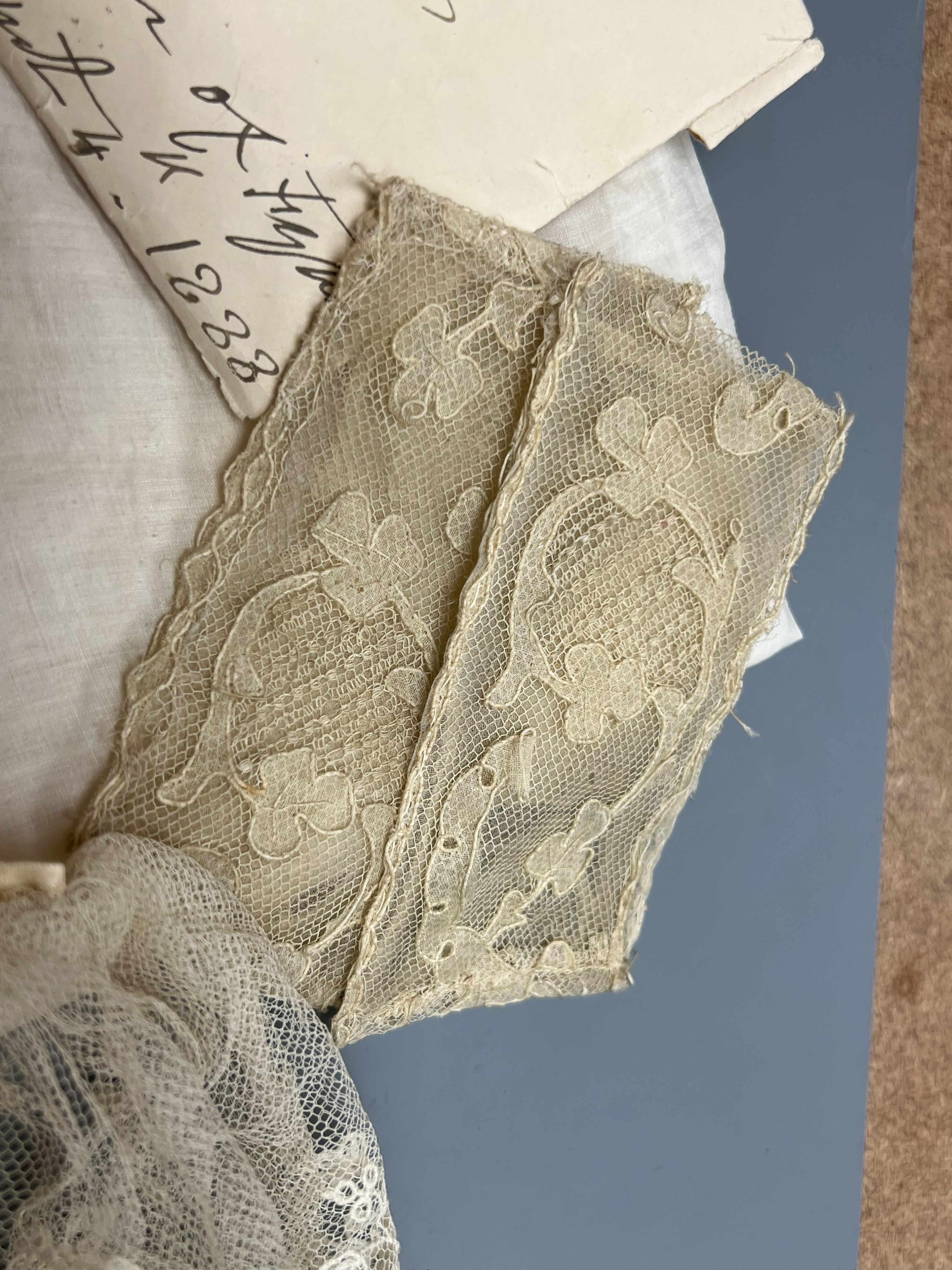 A George III handkerchief with George III cypher and three pieces of lace (4)